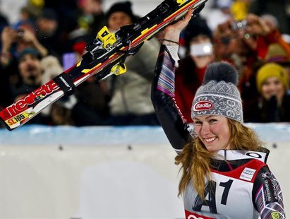 Mikaela Shiffrin from the U.S. celebrates with the trophy after winning the World Cup women's slalom race in Flachau January 14, 2014. REUTE Mikaela Shiffrin from the U.S. celebrates with the trophy after winning the World Cup women's slalom race in Flachau January 14, 2014. REUTE
