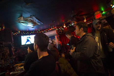 People watch the NFC championship football game between the Seattle Seahawks and the San Francisco 49ers in Jersey City, New Jersey January People watch the NFC championship football game between the Seattle Seahawks and the San Francisco 49ers in Jersey City, New Jersey January