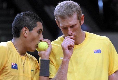Australia's Nick Kyrgios and Chris Guccione (R) talk during their Davis Cup play-off doubles tennis match against Poland's Mariusz Fyrstenbe Australia's Nick Kyrgios and Chris Guccione (R) talk during their Davis Cup play-off doubles tennis match against Poland's Mariusz Fyrstenbe