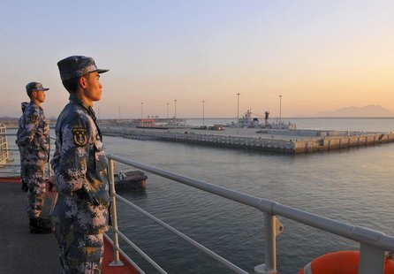 Chinese naval soldiers stand guard on China's first aircraft carrier Liaoning, as it travels towards a military base in Sanya, Hainan provin Chinese naval soldiers stand guard on China's first aircraft carrier Liaoning, as it travels towards a military base in Sanya, Hainan provin