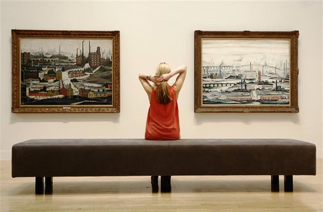 A file photograph shows a Tate employee posing for a photograph with works by British artist L.S.Lowry at Tate Britain in London June 24, 20 A file photograph shows a Tate employee posing for a photograph with works by British artist L.S.Lowry at Tate Britain in London June 24, 20