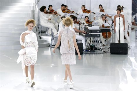Models present creations by German designer Karl Lagerfeld for French fashion house Chanel as part of his Haute Couture Spring/Summer 2014 f Models present creations by German designer Karl Lagerfeld for French fashion house Chanel as part of his Haute Couture Spring/Summer 2014 f