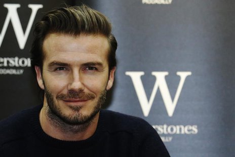 Retired soccer player David Beckham poses with his book "David Beckham" at a bookshop in London December 19, 2013. REUTERS/Luke MacGregor Retired soccer player David Beckham poses with his book "David Beckham" at a bookshop in London December 19, 2013. REUTERS/Luke MacGregor