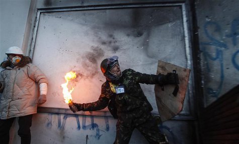 A pro-European integration protester throws a Molotov cocktail towards riot police during clashes in Kiev January 20, 2014. REUTERS/Vasily F A pro-European integration protester throws a Molotov cocktail towards riot police during clashes in Kiev January 20, 2014. REUTERS/Vasily F