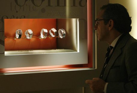 A visitor looks at watches at the Parmigiani booth during the opening day of the "Salon International de la Haute Horlogerie" at Palexpo in A visitor looks at watches at the Parmigiani booth during the opening day of the "Salon International de la Haute Horlogerie" at Palexpo in