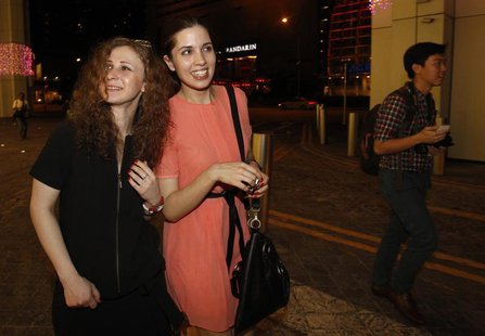 Members of Russian punk rock band Pussy Riot, Nadezhda Tolokonnikova (C) and Maria Alyokhina, leave the inaugural Prudential Eye Awards in S Members of Russian punk rock band Pussy Riot, Nadezhda Tolokonnikova (C) and Maria Alyokhina, leave the inaugural Prudential Eye Awards in S