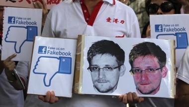 A demonstrator from the pro "Caring Hong Kong Power" group holds up a sign of Eric Snowden protesting the National Security Agency spying on National Chinese territory. Reuters/Bobby Yip A demonstrator from the pro "Caring Hong Kong Power" group holds up a sign of Eric Snowden protesting the National Security Agency spying on National Chinese territory. Reuters/Bobby Yip