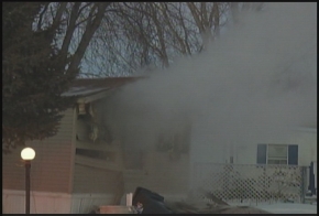 Smoke is seen, drifting out of the window of the mobile home Smoke is seen, drifting out of the window of the mobile home