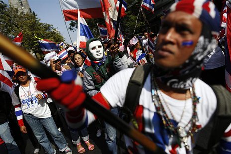 Anti-government protesters wave flags as they march through Bangkok's financial district January 21, 2014. REUTERS/Damir Sagolj Anti-government protesters wave flags as they march through Bangkok's financial district January 21, 2014. REUTERS/Damir Sagolj