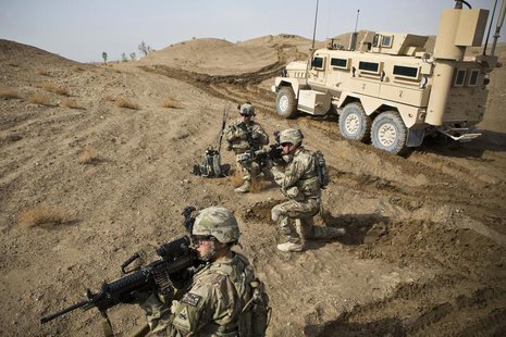 U.S. Army soldiers with Charlie Company, 36th Infantry Regiment, 1st Armored Division set up a supportive position during a mission near Com U.S. Army soldiers with Charlie Company, 36th Infantry Regiment, 1st Armored Division set up a supportive position during a mission near Com
