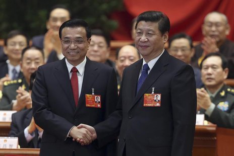 China's President Xi Jinping shakes hands with China's newly elected Premier Li Keqiang (L) as other delegates clap during the fifth plenary China's President Xi Jinping shakes hands with China's newly elected Premier Li Keqiang (L) as other delegates clap during the fifth plenary