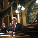 Michigan's Governor Rick Snyder (C) is acknowledged by the Assembly before his annual State of the State address at the State Capitol in Lan Michigan's Governor Rick Snyder (C) is acknowledged by the Assembly before his annual State of the State address at the State Capitol in Lan