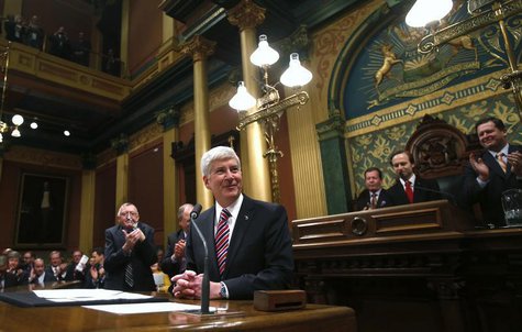 Michigan's Governor Rick Snyder (C) is acknowledged by the Assembly before his annual State of the State address at the State Capitol in Lan Michigan's Governor Rick Snyder (C) is acknowledged by the Assembly before his annual State of the State address at the State Capitol in Lan