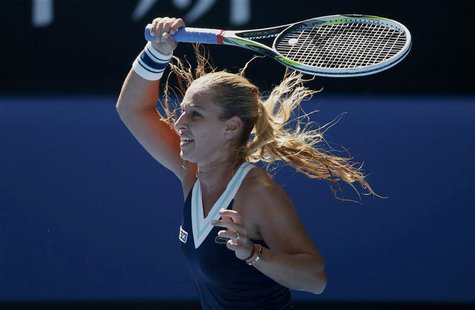 Dominika Cibulkova of Slovakia hits a return to Agnieszka Radwanska of Poland during their women's singles semi-final match at the Australia Dominika Cibulkova of Slovakia hits a return to Agnieszka Radwanska of Poland during their women's singles semi-final match at the Australia
