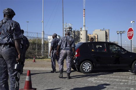 Armed security officers search cars outside the Lonmin mine in Rustenburg, northwest of Johannesburg January 23, 2014. REUTERS/Siphiwe Sibek Armed security officers search cars outside the Lonmin mine in Rustenburg, northwest of Johannesburg January 23, 2014. REUTERS/Siphiwe Sibek