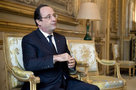 French President Francois Hollande reacts during a meeting with a guest in his office at the Elysee Palace in Paris, January 22, 2014. REUTE French President Francois Hollande reacts during a meeting with a guest in his office at the Elysee Palace in Paris, January 22, 2014. REUTE