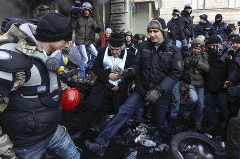 Opposition leader Vitaly Klitschko (C) greets a pro-European integration protester at the site of clashes with riot police in Kiev January 2 Opposition leader Vitaly Klitschko (C) greets a pro-European integration protester at the site of clashes with riot police in Kiev January 2