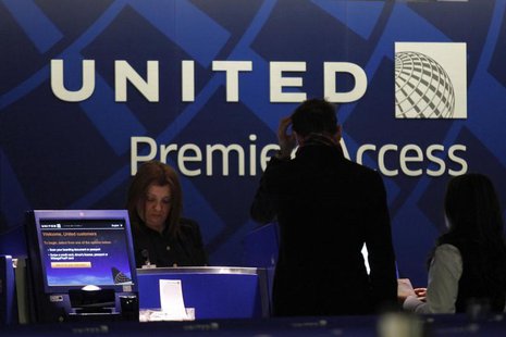 A worker from United attends to some customers during their check in process at Newark International airport in New Jersey , November 15, 20 A worker from United attends to some customers during their check in process at Newark International airport in New Jersey , November 15, 20