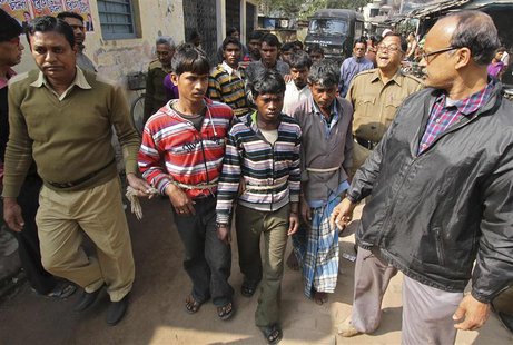 Indian police personnel escort men (tied with rope), who are accused of a gang-rape, to a court at Birbhum district in the eastern Indian st Indian police personnel escort men (tied with rope), who are accused of a gang-rape, to a court at Birbhum district in the eastern Indian st