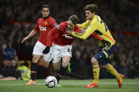 Manchester United's Adnan Januzaj (C) challenges Sunderland's Marcos Alonso during their English League Cup semi-final second leg soccer mat Manchester United's Adnan Januzaj (C) challenges Sunderland's Marcos Alonso during their English League Cup semi-final second leg soccer mat