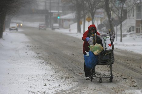 A man pushes a cart up the road while scavenging for bottles and cans during a winter nor'easter snowstorm in Lynn, Massachusetts January 2, A man pushes a cart up the road while scavenging for bottles and cans during a winter nor'easter snowstorm in Lynn, Massachusetts January 2,