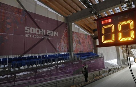 A worker prepares a bobsleigh, luge and skeleton track for a competition at the Sliding Center "Sanki", near Krasnaya Polyana near Sochi, Ja A worker prepares a bobsleigh, luge and skeleton track for a competition at the Sliding Center "Sanki", near Krasnaya Polyana near Sochi, Ja
