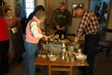 Participants in a past Hearthside Dinner work on preparing the food. Participants in a past Hearthside Dinner work on preparing the food.
