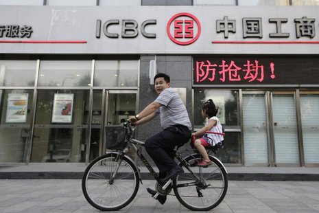 A man and his daughter ride a bicycle past a branch of the Industrial and Commercial Bank of China Ltd (ICBC) in Beijing June 26, 2013. REUT A man and his daughter ride a bicycle past a branch of the Industrial and Commercial Bank of China Ltd (ICBC) in Beijing June 26, 2013. REUT