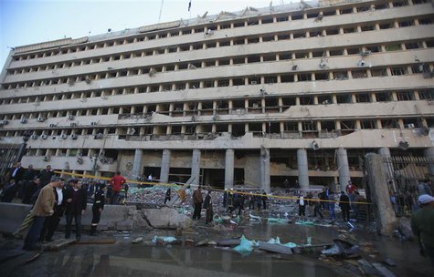 Police officers and people gather in front of the damaged Cairo Security Directorate, which includes police and state security, after a bomb Police officers and people gather in front of the damaged Cairo Security Directorate, which includes police and state security, after a bomb