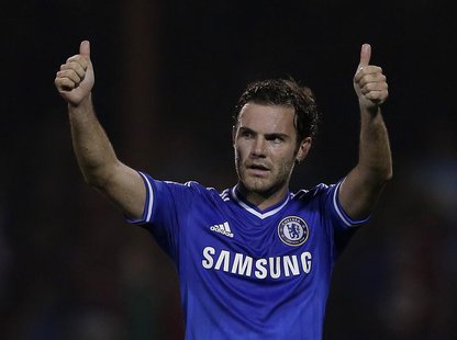 Chelsea's Juan Mata acknowledges the fans after winning their game against Swindon Town in their English League Cup soccer match at the Coun Chelsea's Juan Mata acknowledges the fans after winning their game against Swindon Town in their English League Cup soccer match at the Coun