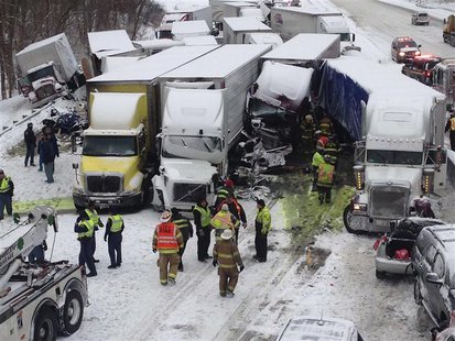 Trucks and passenger vehicles block eastbound Interstate 94 following a massive crash that killed three people and injured about 20 near Mic Trucks and passenger vehicles block eastbound Interstate 94 following a massive crash that killed three people and injured about 20 near Mic