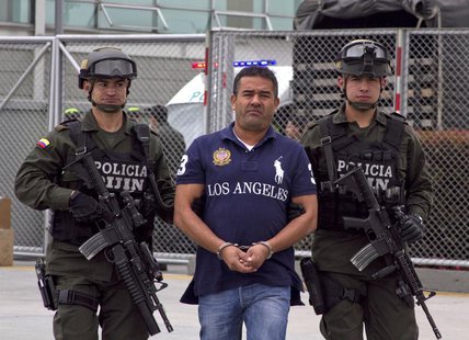 Colombian alleged drug trafficker Diego Perez Henao is escorted by policemen before being extradited from Bogota August 28, 2013. REUTERS/In Colombian alleged drug trafficker Diego Perez Henao is escorted by policemen before being extradited from Bogota August 28, 2013. REUTERS/In