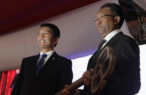 Madagascar's newly elected President Hery Rajaonarimampianina (R) receives the key symbolising the transfer of power from outgoing president Madagascar's newly elected President Hery Rajaonarimampianina (R) receives the key symbolising the transfer of power from outgoing president