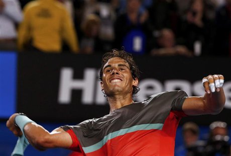 Rafael Nadal of Spain throws his sweatbands into the crowd as he celebrates defeating Roger Federer of Switzerland in their men's singles se Rafael Nadal of Spain throws his sweatbands into the crowd as he celebrates defeating Roger Federer of Switzerland in their men's singles se