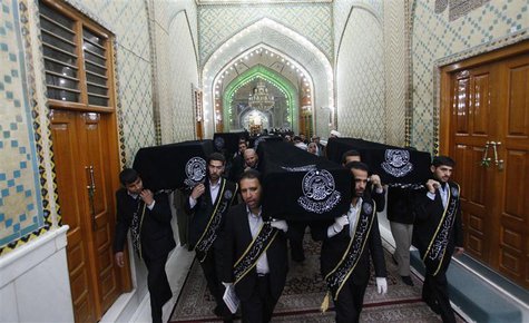 Mourners carry the coffins of victims killed by a bomb attack at a Shi'ite Muslim village near the Iraqi city of Baquba, during a funeral at Mourners carry the coffins of victims killed by a bomb attack at a Shi'ite Muslim village near the Iraqi city of Baquba, during a funeral at