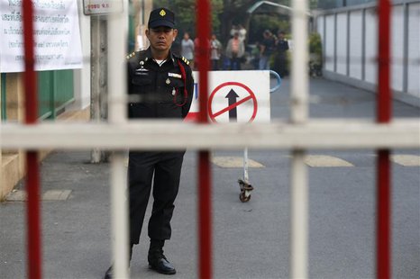 A Bangkok district officer stands inside the compound of a polling station in central Bangkok January 26, 2014. Thai authorities told anti-g A Bangkok district officer stands inside the compound of a polling station in central Bangkok January 26, 2014. Thai authorities told anti-g