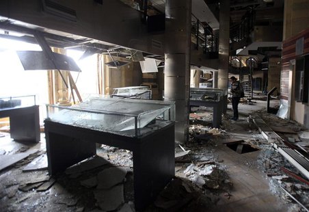 An antiquities restoration worker looks inside the Egyptian National Library and Archives, which was damaged by a car bomb attack targeting An antiquities restoration worker looks inside the Egyptian National Library and Archives, which was damaged by a car bomb attack targeting