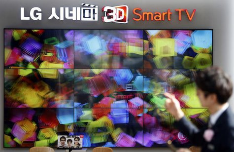 An employee works in front of LG Electronics' 3D TV sets which are made with LG Display flat screens at its store in Seoul January 23, 2014. An employee works in front of LG Electronics' 3D TV sets which are made with LG Display flat screens at its store in Seoul January 23, 2014.