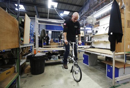 Dino Martins give a bike its final inspection at the Brompton Bicycle factory in west London January 10, 2014. REUTERS/Luke MacGregor Dino Martins give a bike its final inspection at the Brompton Bicycle factory in west London January 10, 2014. REUTERS/Luke MacGregor