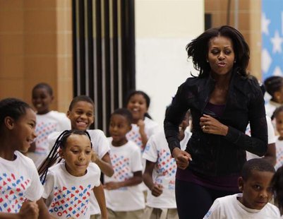 U.S. First Lady Michelle Obama jogs with children at a back-to-school event at Orr Elementary School in Washington September 6, 2013. REUTER U.S. First Lady Michelle Obama jogs with children at a back-to-school event at Orr Elementary School in Washington September 6, 2013. REUTER