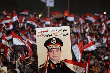 Supporters of Egypt's army chief General Abdel Fattah al-Sisi holds a poster of Sisi in Tahrir square in Cairo, on the third anniversary of Supporters of Egypt's army chief General Abdel Fattah al-Sisi holds a poster of Sisi in Tahrir square in Cairo, on the third anniversary of
