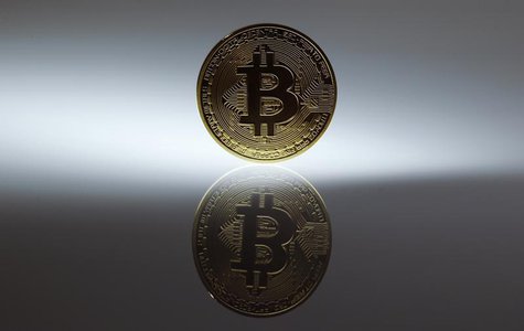 A mock Bitcoin is displayed on a table in an illustration picture taken in Berlin January 7, 2014. REUTERS/Pawel Kopczynski A mock Bitcoin is displayed on a table in an illustration picture taken in Berlin January 7, 2014. REUTERS/Pawel Kopczynski