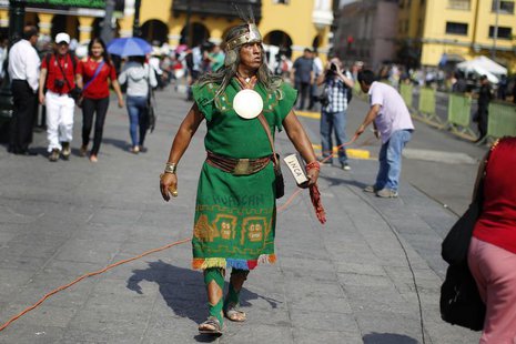 A man dressed as a native Inca walks as he watches the final ruling court session of a decades-old maritime dispute between Peru and Chile, A man dressed as a native Inca walks as he watches the final ruling court session of a decades-old maritime dispute between Peru and Chile,