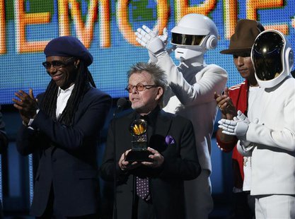 Producer Paul Williams accepts the award for Album of the year for Daft Punk's "Random Access Memories" as Nile Rodgers (L) and Pharrell Wil Producer Paul Williams accepts the award for Album of the year for Daft Punk's "Random Access Memories" as Nile Rodgers (L) and Pharrell Wil