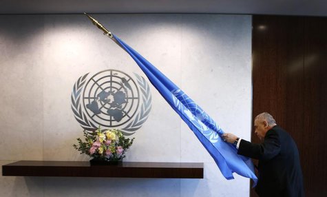 An attendant carries the United Nations flag into a meeting room before U.N. Secretary-General Ban Ki-moon meets Norway's Foreign Minister B An attendant carries the United Nations flag into a meeting room before U.N. Secretary-General Ban Ki-moon meets Norway's Foreign Minister B