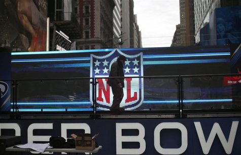 A worker walks on a stage in front of the NFL logo in New York's Times Square January 27, 2014. REUTERS/Mike Segar A worker walks on a stage in front of the NFL logo in New York's Times Square January 27, 2014. REUTERS/Mike Segar