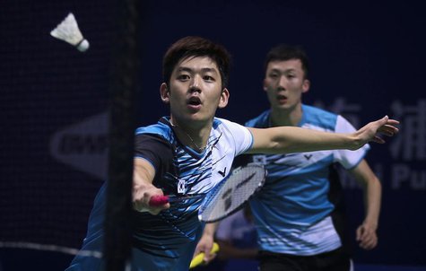 South Korea's Lee Yong-dae (L) hits a return next to his partner Yoo Yeon-seong during their men's doubles semi-final match against Japan's South Korea's Lee Yong-dae (L) hits a return next to his partner Yoo Yeon-seong during their men's doubles semi-final match against Japan's