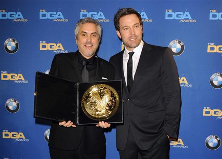 Actor and director Ben Affleck (R) presents Mexican director Alfonso Cuaron with the Feature Film award for "Gravity" during the 66th annual Actor and director Ben Affleck (R) presents Mexican director Alfonso Cuaron with the Feature Film award for "Gravity" during the 66th annual