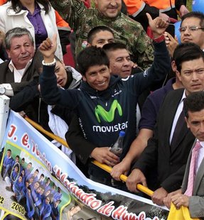 Colombian cyclist Nairo Quintana (gesturing) greets fans upon his arrival at Bogota Airport August 13, 2013. REUTERS/Jose Miguel Gomez Colombian cyclist Nairo Quintana (gesturing) greets fans upon his arrival at Bogota Airport August 13, 2013. REUTERS/Jose Miguel Gomez