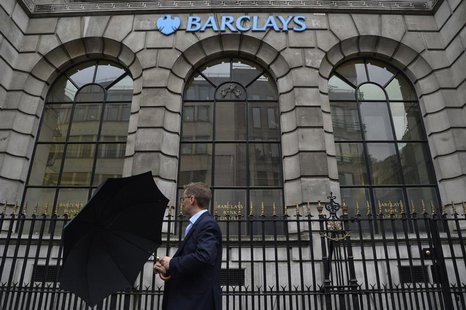 A man lifts his umbrella as he walks past a branch of Barclays bank in London July 30, 2013. REUTERS/Toby Melville A man lifts his umbrella as he walks past a branch of Barclays bank in London July 30, 2013. REUTERS/Toby Melville